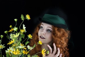 Woman wearing top hat with green tulle and flowers
