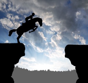 silhouette of a rider on a jumping horse